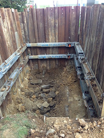 Install shoring and concrete base